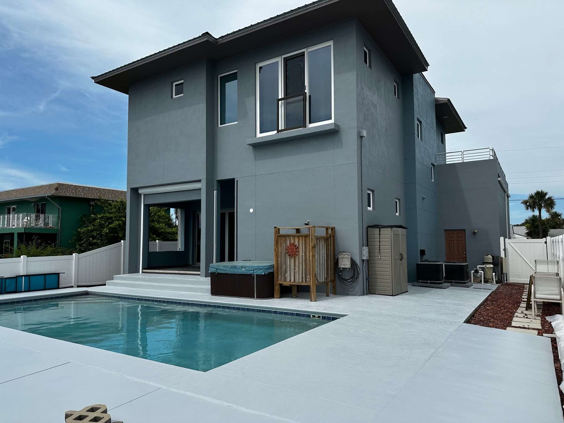 After: the gray exterior from the poolside.