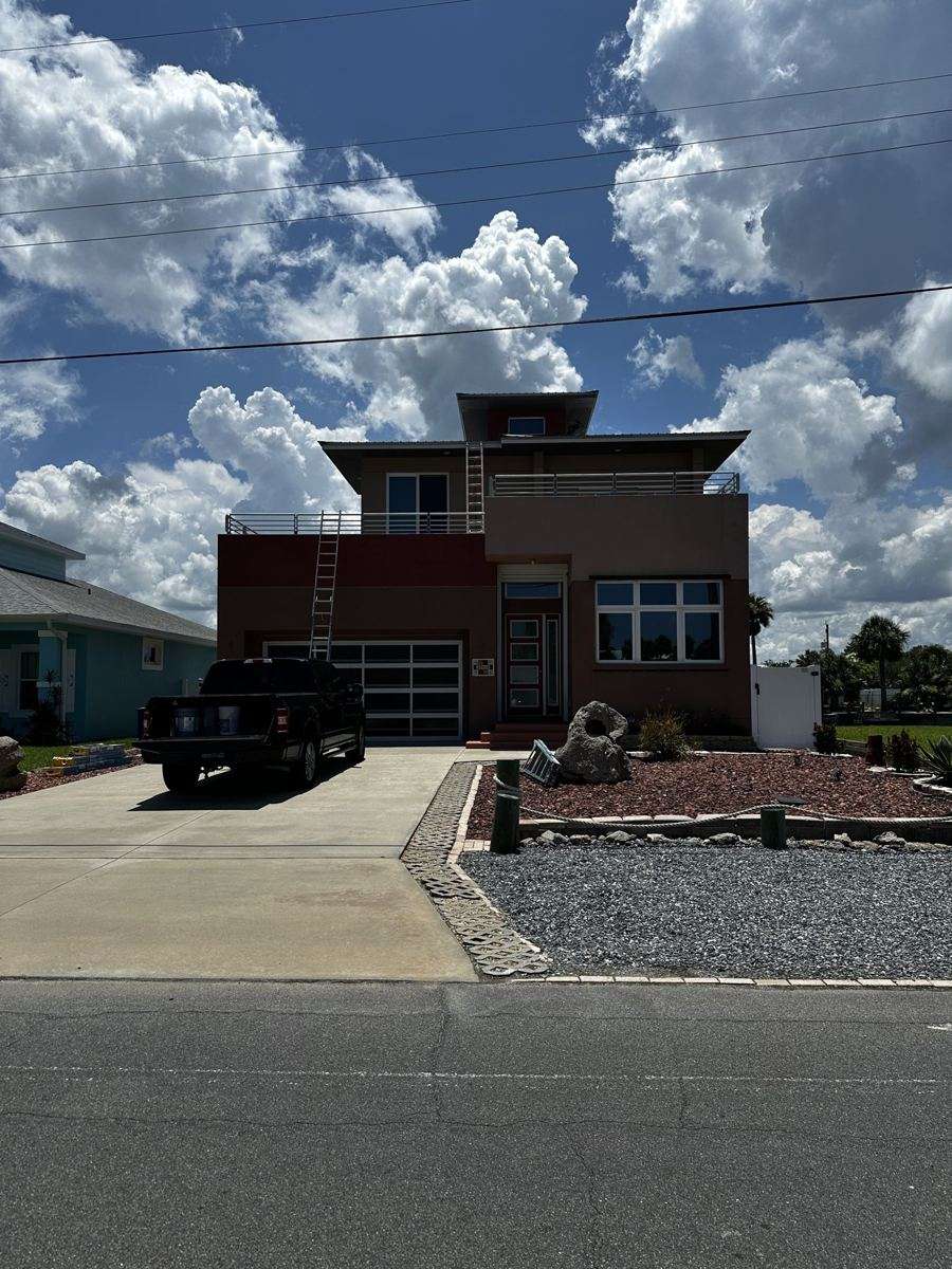 Before: the warm brown exterior of this Flagler Beach home.