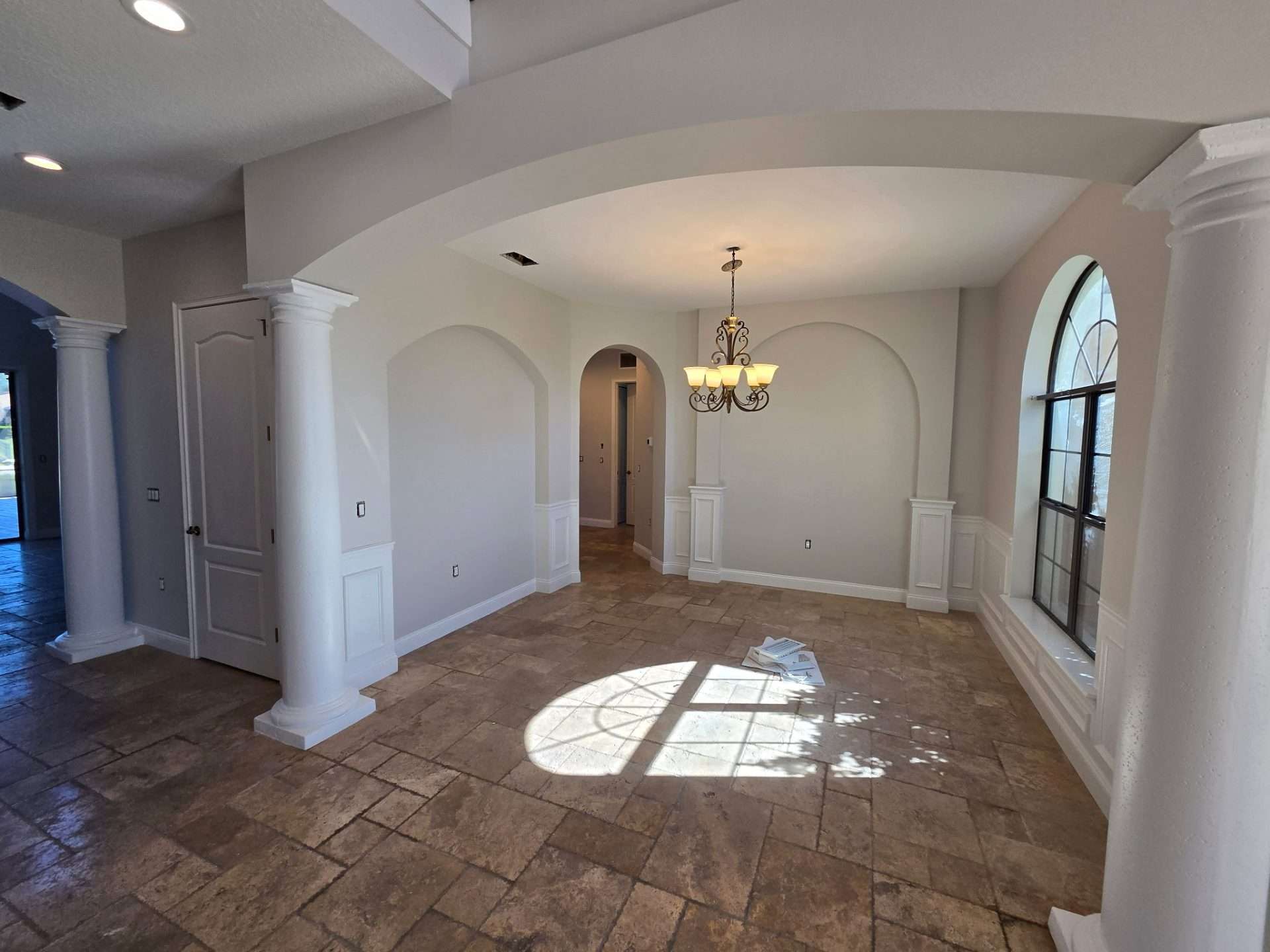 Palm Coast dining room with freshly painted neutral walls, arched windows and white trim